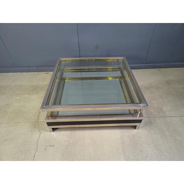 Vintage display coffee table with a sliding glass top. This luxurious coffee table is made from heavy quality polished...