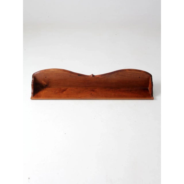 This is an antique wooden shelf. The wood mantel features a scalloped back design and sides. To be used atop a table or...