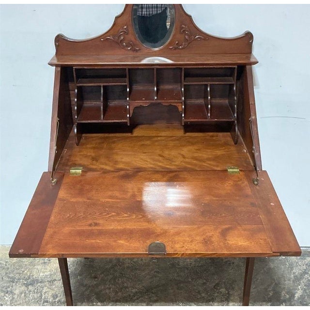 A rare and striking Victorian secretary desk in warm walnut with the kind of presence that stops a room. The carved...