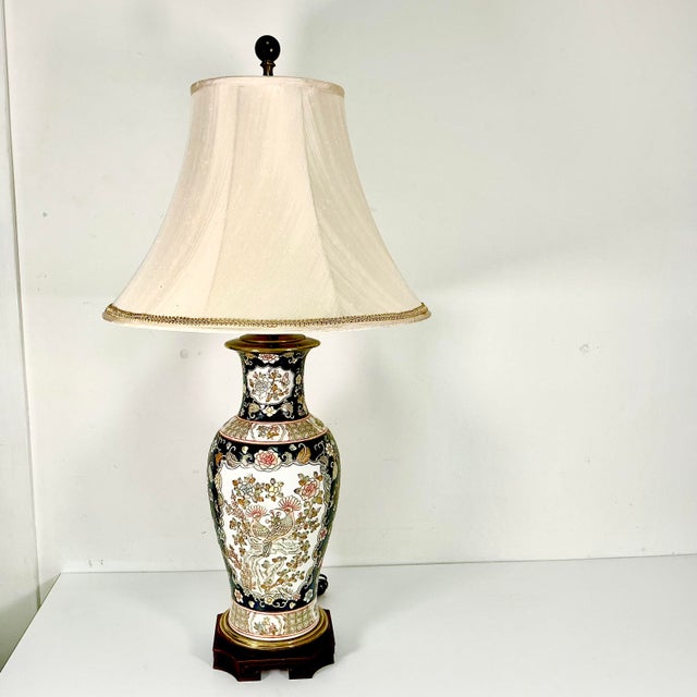 This is a stunning Chinoiserie tall Table Lamp from the 1970s. It features two peacocks on one side and a pair of...