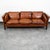 Nicely worn in Danish modern 3 seater cognac leather sofa from the 70s, with wooden legs. The leather is rich and thick...