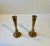 A heavy pair of bronze taper candlesticks executed with architectural features. Designed and manufactured by th. P. In...
