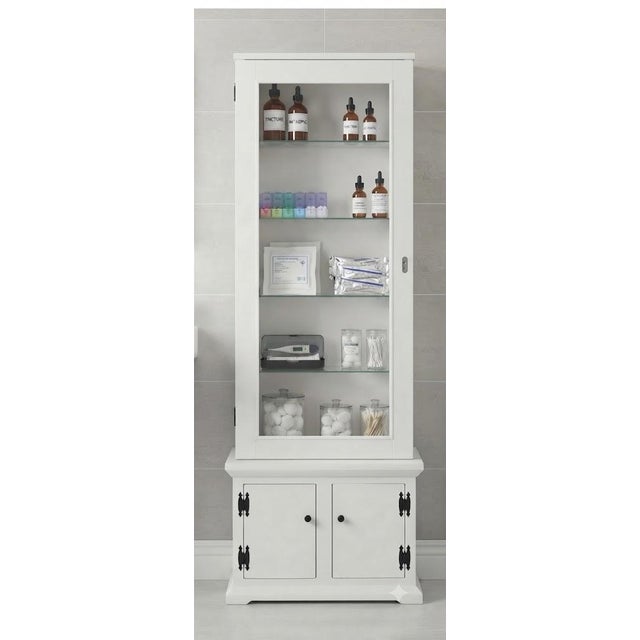 Charming Farmhouse Glass-Door Cabinet from Virginia Estate Transform your space with this charming, vintage-inspired white...