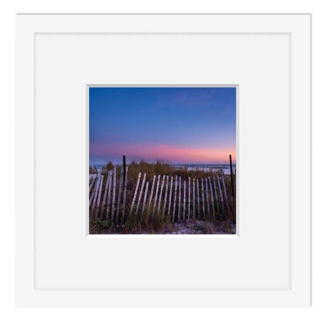 This fine art photograph by Paula McIntosh was taken in Charleston, South Carolina. A Lowcountry sunset behind the dunes....