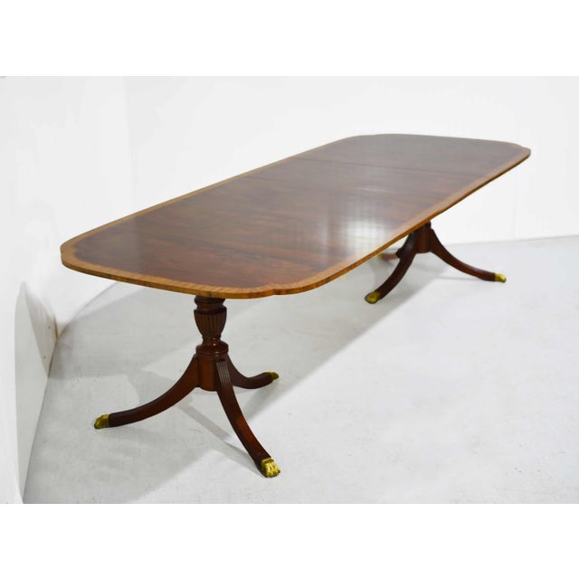 This "Baker Charleston Edition" style dining table features a classic silhouette with elegant banding. Crafted from solid...