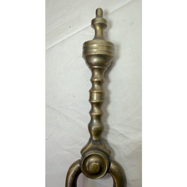 Up for sale is a nice pair of rare antique 18th century wrought iron and brass English fireplace tongs. The arms are...