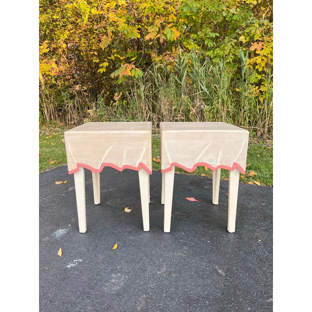 A whimsical pair of 1980s side tables carved to look like draped tablecloths. Each has soft folds, corner pleats, and a...