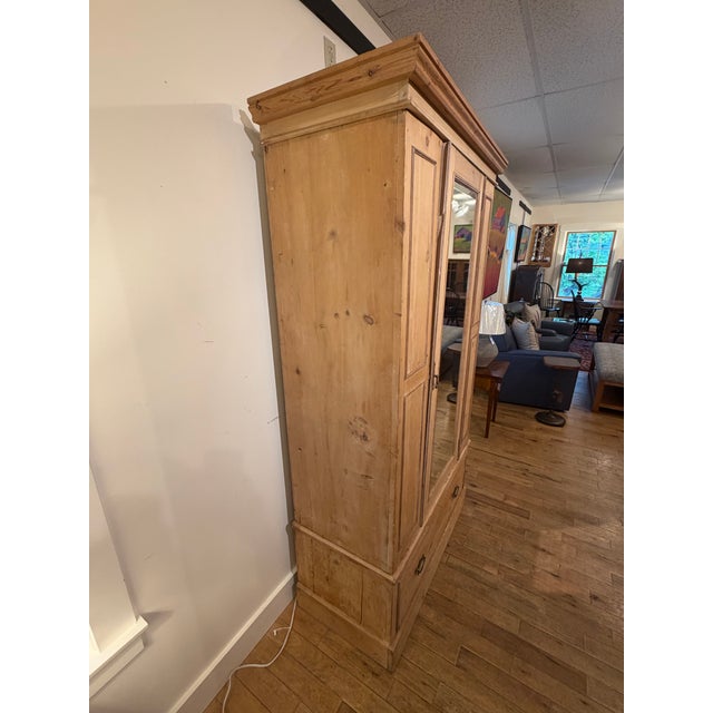 Up for sale in Sunapee Harbor is an Antique Scrubbed Pine Armoire. This particular piece came from the national Brimfield...