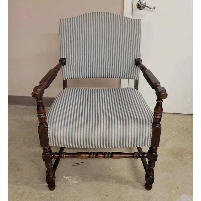Traditional but unusual, upholstered occasional chair with open wood arms having a knob at the ends. Upholstered in an...