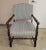 Traditional but unusual, upholstered occasional chair with open wood arms having a knob at the ends. Upholstered in an...