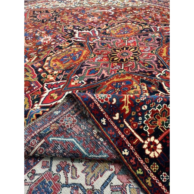Decorate your space with the striking beauty of this 10x13 Old Persian Heriz area rug. Handmade in Persia from wool, the...