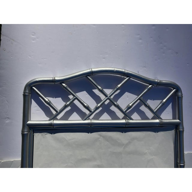 This carved wooden mirror was made in the 70’s The faux bamboo style is painted. Silver Nice quality carving Height 47...