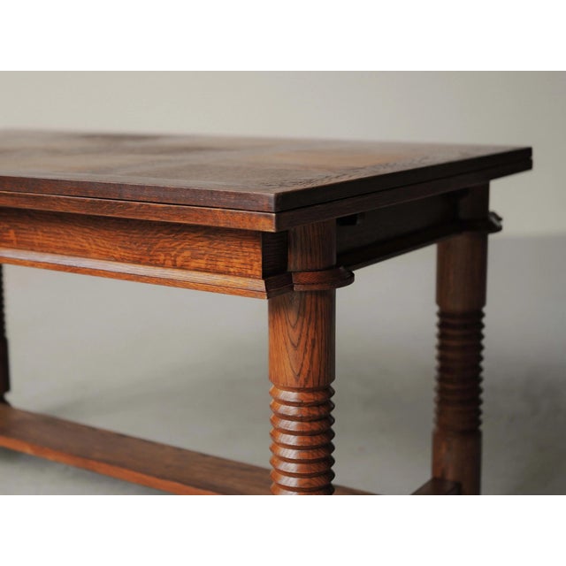 Solid oak dining table features a rectangular top with side extensions, allowing it to expand from 140 cm to 240 cm in...