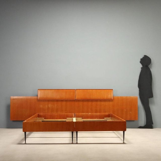 1960s double bed designed by Silvio Cavatorta, crafted in teak wood. This piece exemplifies the elegant and functional...