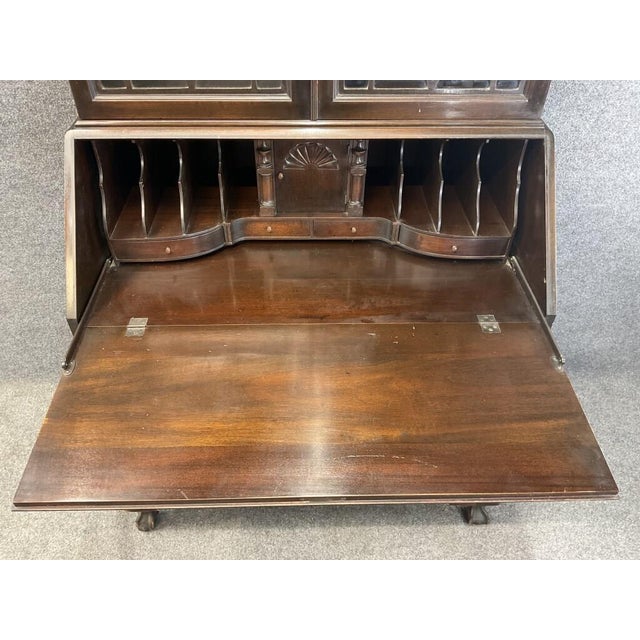 An impressive antique solid mahogany secretary bookcase made by the Colonial Manufacturing Company of Zeeland, Michigan....