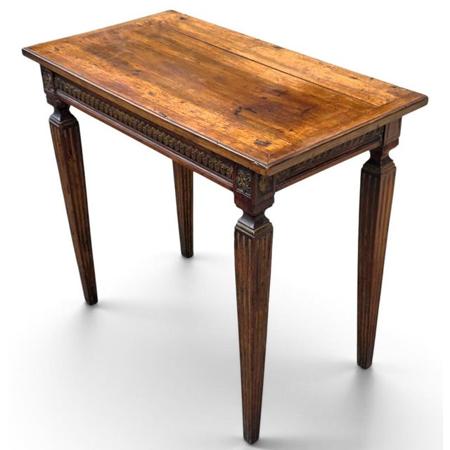 A charming late 18th-century French Louis XVI provincial petite writing table, dating to circa 1790, crafted in richly...