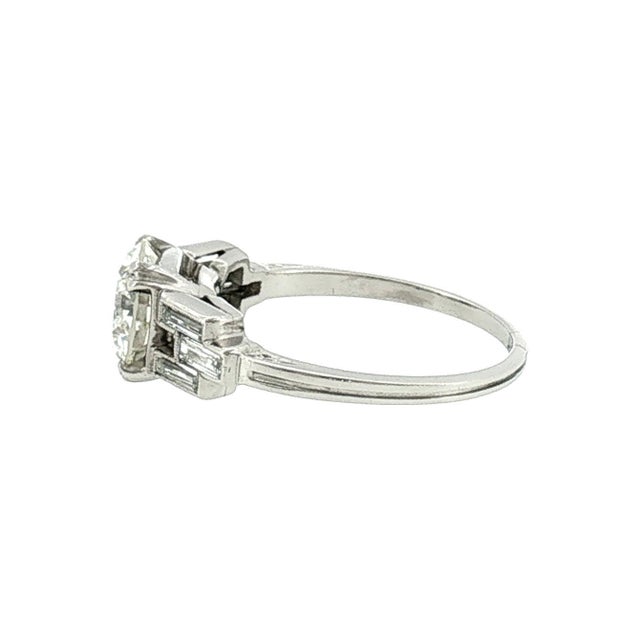 An Art Deco platinum engagement ring. Features a 2.03 carat transitional-brilliant-cut white diamond, VS1 clarity, K color...