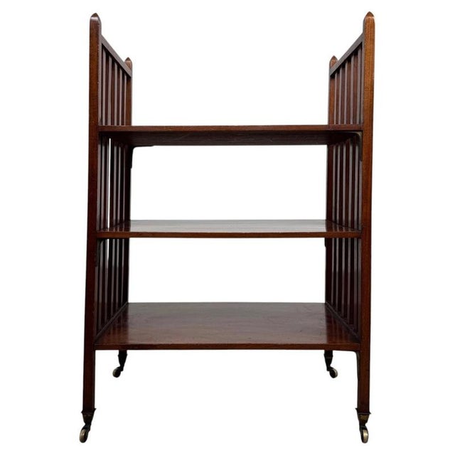 A distinctive early 20th-century English open bookcase, finely crafted from mahogany and distinguished by its unusual...