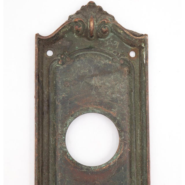 Traditional style bronze Sargent entry door back plate with a dark patina and lock insert. Inscribed Sargent & Co. VF on...