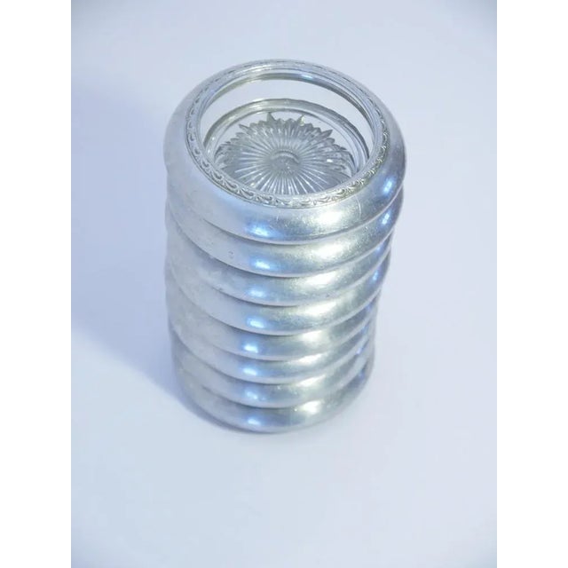 This matching set of 8 coasters is made of glass and pewter rims. Some very slight marks on a few coasters, so marking as...