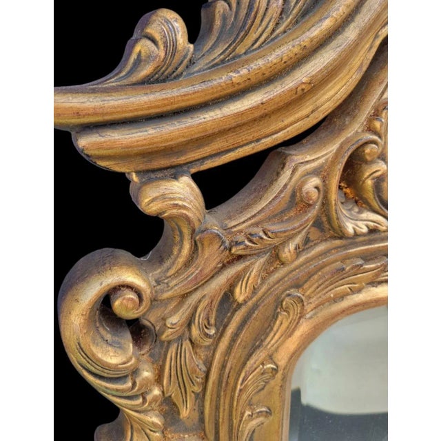 A wonderful vintage large gold gilt regency wall mirror. The mirror is made of a somewhat light weight composite material....