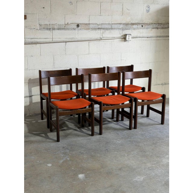 Set of 6 vintage Danish dining chairs designed by Hans Wegner for Getama, featuring solid teak frames and vibrant orange...
