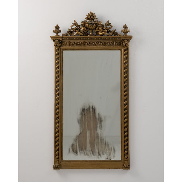 A 19th century French wall mirror in the Napoleon III style, featuring a structured frame with balanced proportions. The...