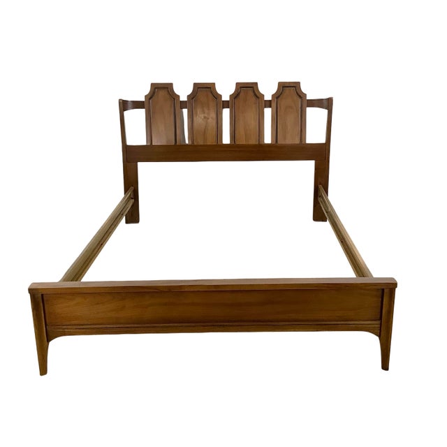 A striking Mid-Century Modern bed frame in warm walnut tones, sized to fit a full (double) mattress. The headboard is the...