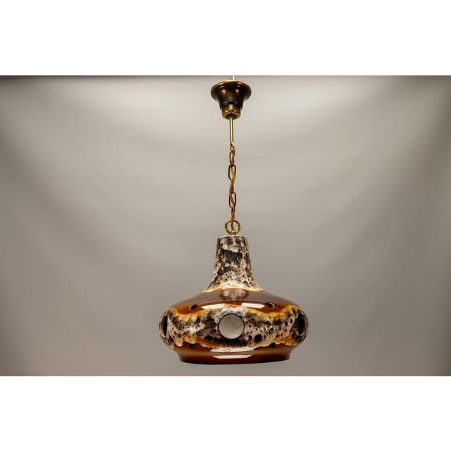 German Fat Lava pendant light, circa 1970s. Sculptural ceramic shade with richly textured glaze in brown, ochre, and cream...