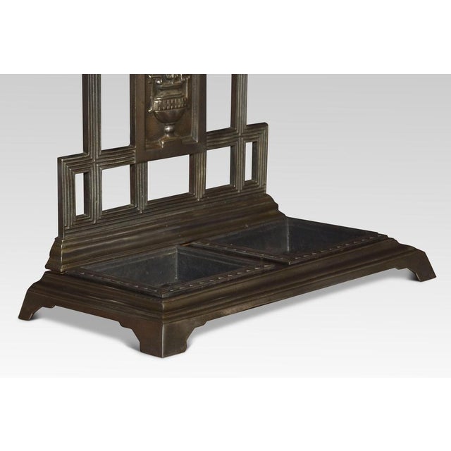 Falkirk cast iron umbrella/stick stand, having an architectural top with flower head and foliated scrolls. The base with a...