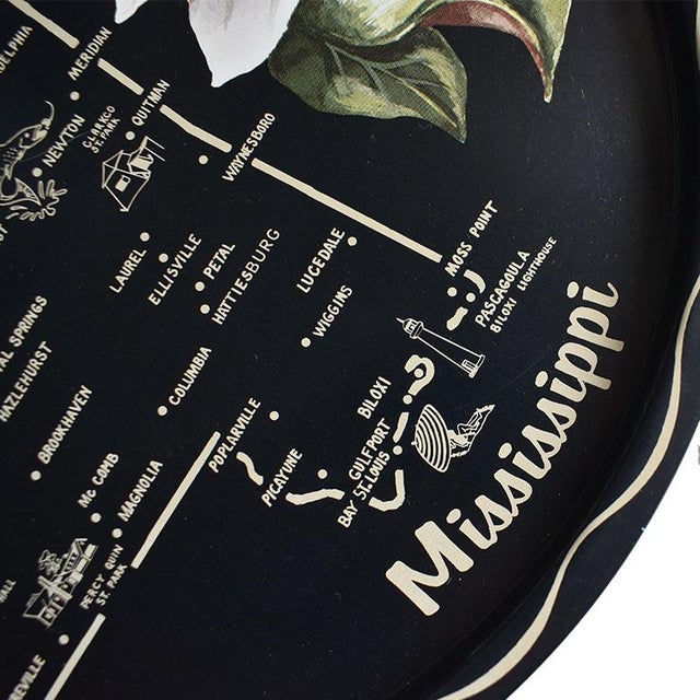 A very southern style metal serving tray decorated with a magnolia flower and the outline of Mississippi with its towns....