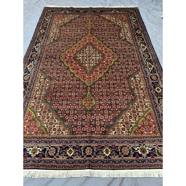 This exquisite Tabriz Mahi rug showcases the celebrated Herati "fish" design: a dense, finely scaled lattice of diamond...