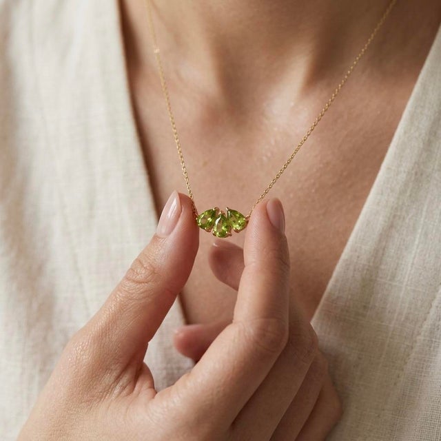 Brighten your jewelry collection with this vibrant cluster pendant necklace, featuring three radiant lime-green gemstones...