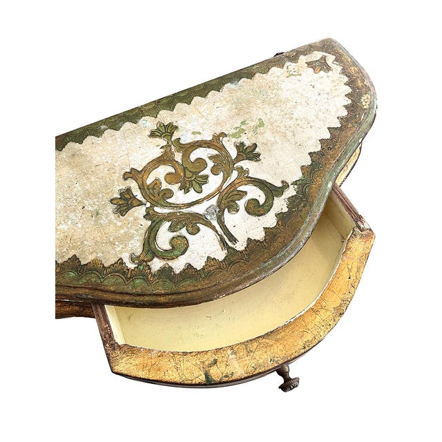This stunning floating console has one petite drawer. The console is painted cream with gold detailing throughout. The...