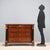 Empire walnut chest of drawers. Four-drawer front, turned and ebonized column uprights with a chased and gilded bronze...