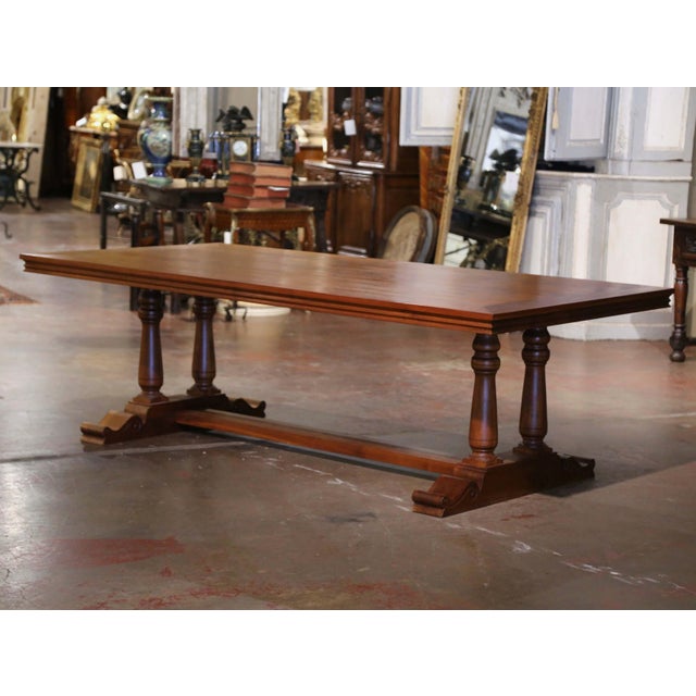 Entertain in style around this large 8 feet long fruitwood dining table. Crafted in France, and built in walnut, the heavy...