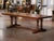 Entertain in style around this large 8 feet long fruitwood dining table. Crafted in France, and built in walnut, the heavy...