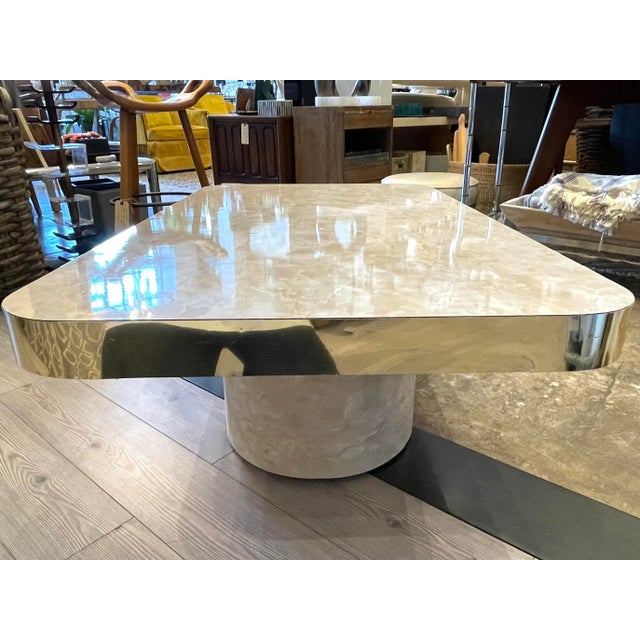 Unique faux marble vinyl coffee table trimmed in gold. Tabletop floats above base clad in faux marble vinyl as well and...