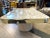 Unique faux marble vinyl coffee table trimmed in gold. Tabletop floats above base clad in faux marble vinyl as well and...