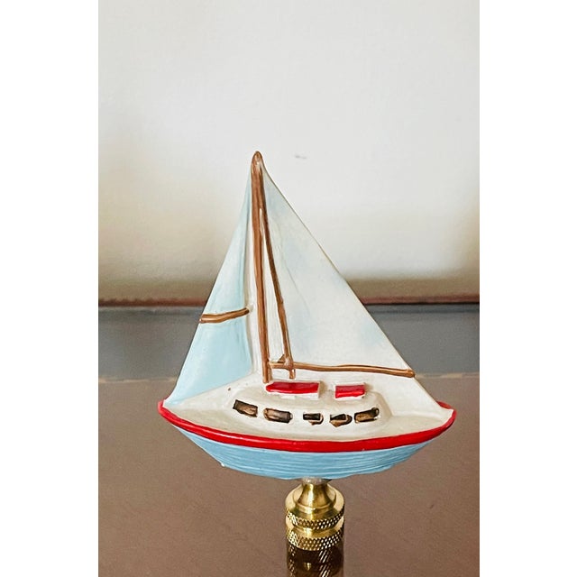 Cute 3” by 3” small sailboat figurine on brass base as lamp finial for coastal home decor.