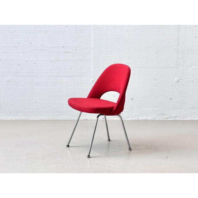 An elegant executive chair by eero saarinen for knoll international, featuring a sculpturally shaped seat shell and a...