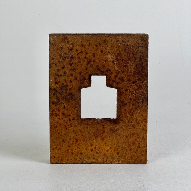 A lovely unidentified piece of salvaged metal object turned sculpture. It's thick solid metal with a cutout in the middle,...