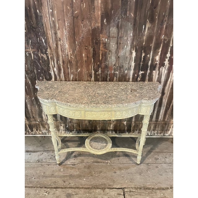 A lovely Adam-style painted console table with an inlaid stone top. The antiqued painted finish on this table is...