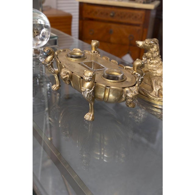 This is an elegant French Empire-style gilt bronze writing stand, richly cast and ornamented with neoclassical and...