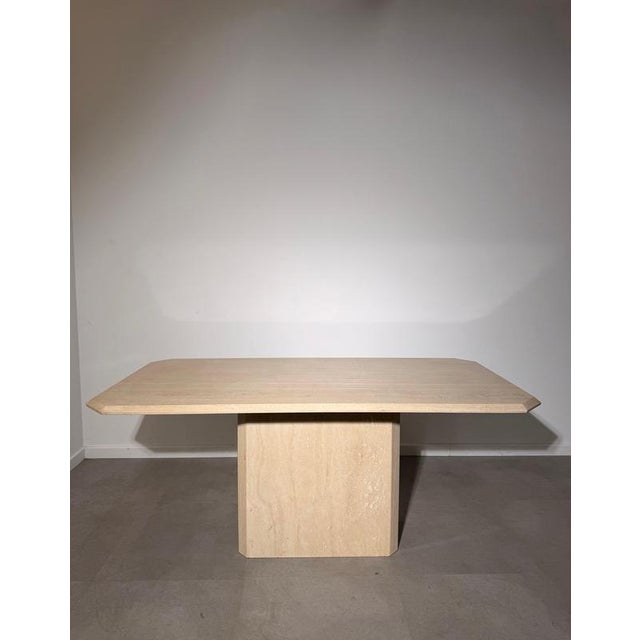 Striking vintage dining table crafted in natural beige travertine , featuring a clean architectural design and beautifully...