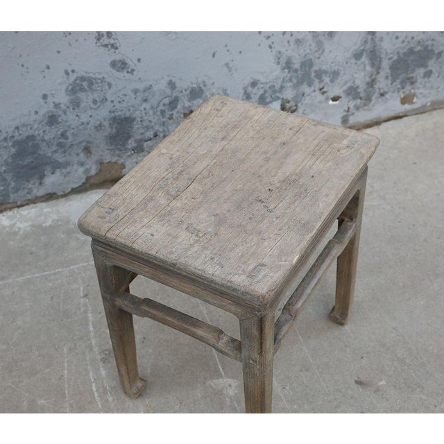 A charming vintage Chinese stool crafted from solid elmwood, dating to the first half of the 20th century. The substantial...