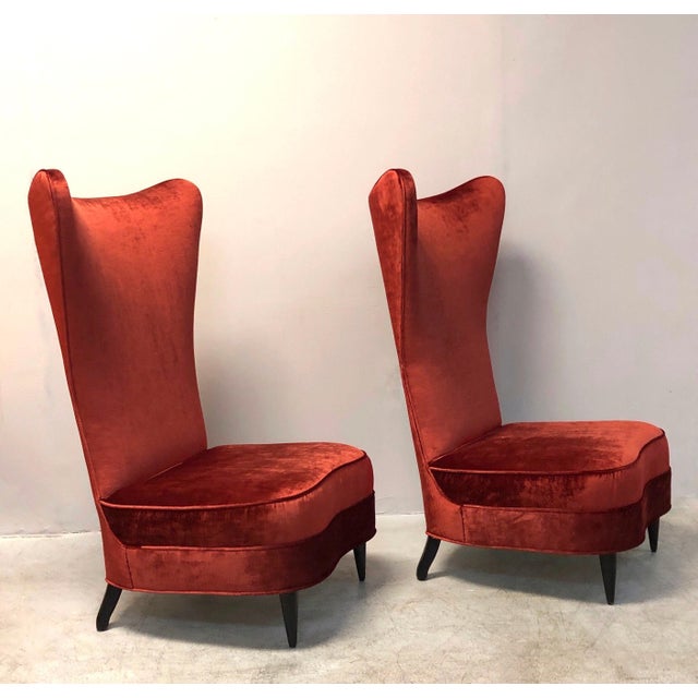 A stylish pair of chairs. Very tall dramatic backs. Ebonized wood legs.