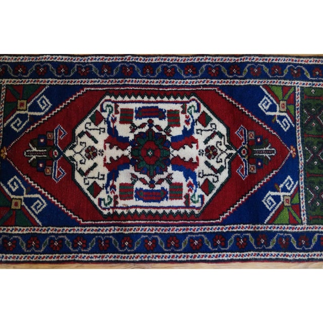 A small vibrant hand knotted rug to accent a small space or to use on the top of a piece of furniture. This Vintage rug is...