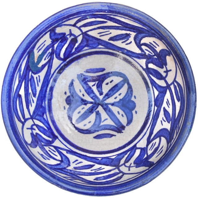 Meticulously handcrafted and glazed Moroccan ceramic bowl exhibiting an elaborate hand-painted pattern in blue and white....