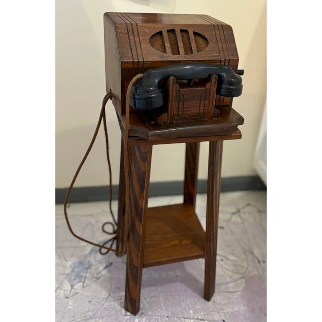 Crank Telephone with Stand. Telephone is 11" wide x 7" tall x 10" deep. Table is 21" tall x 9.5" deep and wide....